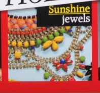 A colourful Alexandria statement necklace by Jolita Jewellery on the cover of the magazine.